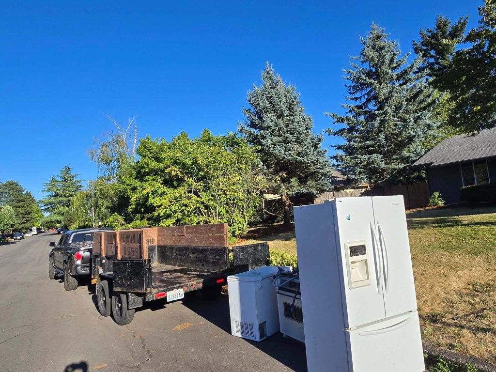 Appliances ready for pickup beside Garcia’s hauling trailer