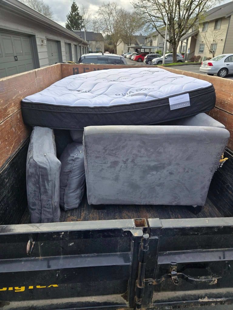 Mattresses and box springs loaded for removal