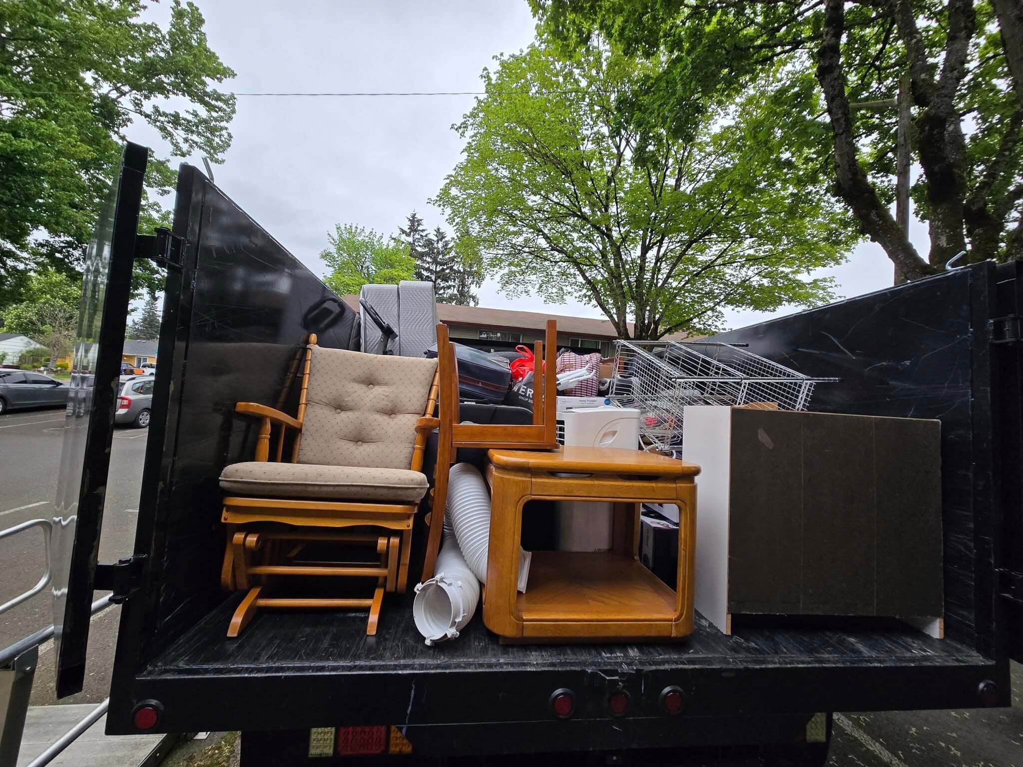 Chairs and bulky furniture loaded for a property cleanout